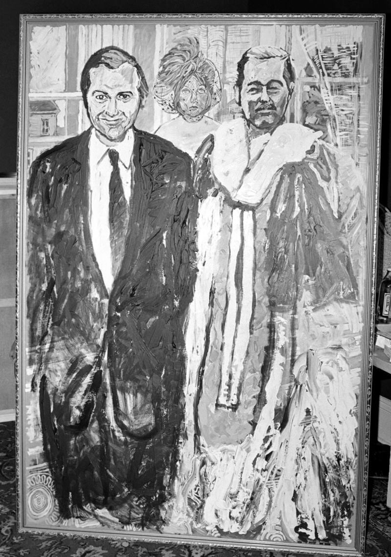 GETTY IMAGES "Los fugitivos", un retrato doble pintado por el británico John Bratby en 1975 de John Stonehouse y Lord Lucan, la pareja de fugitivos más famosa de 1974. La misteriosa mujer velada, es, según dice el artista, "La Diosa de la Catástrofe Psicológica".
