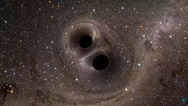 Dos agujeros negros orbitando el uno al otro. Wikipedia.